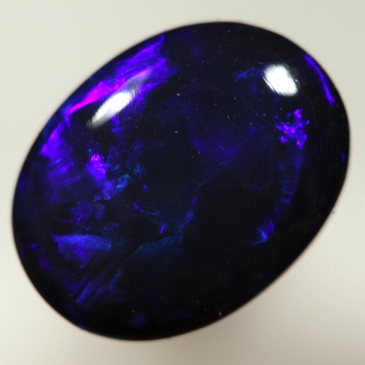 SOLID BLACK OPAL Royal blue rolling flashes. SEE VIDEO